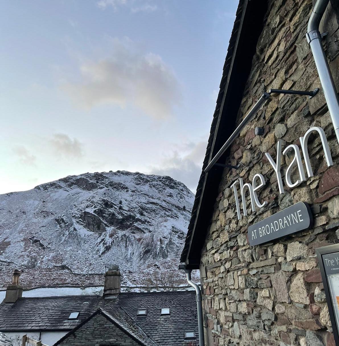 Winter view of The Yan at Broadrayne in Grasmere with snow-covered Helm Crag in the background.